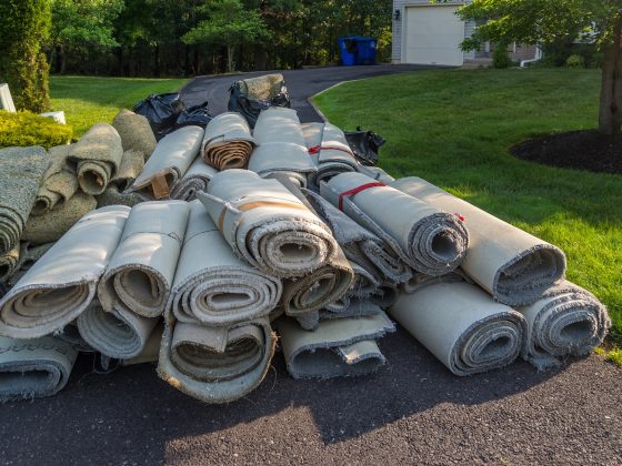 rolls of old carpet on driveway